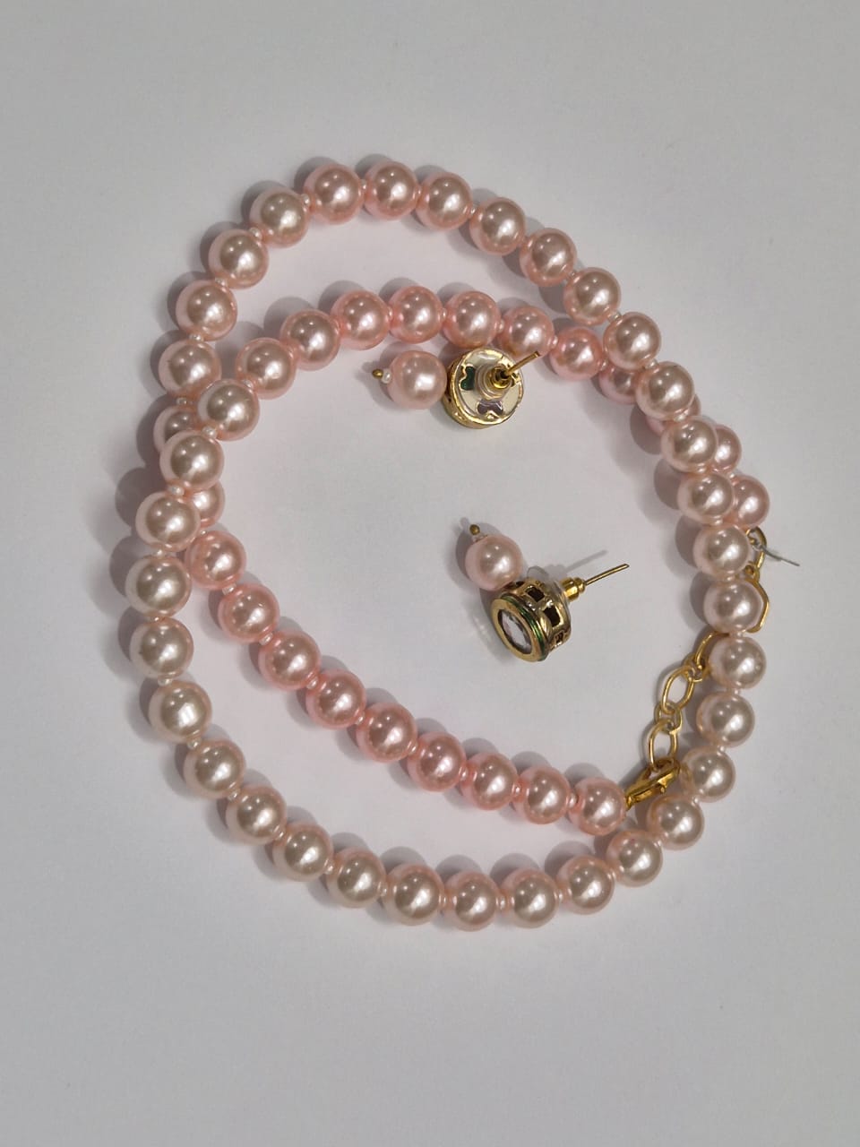Round light pink pearl necklace set with soft, glossy sheen