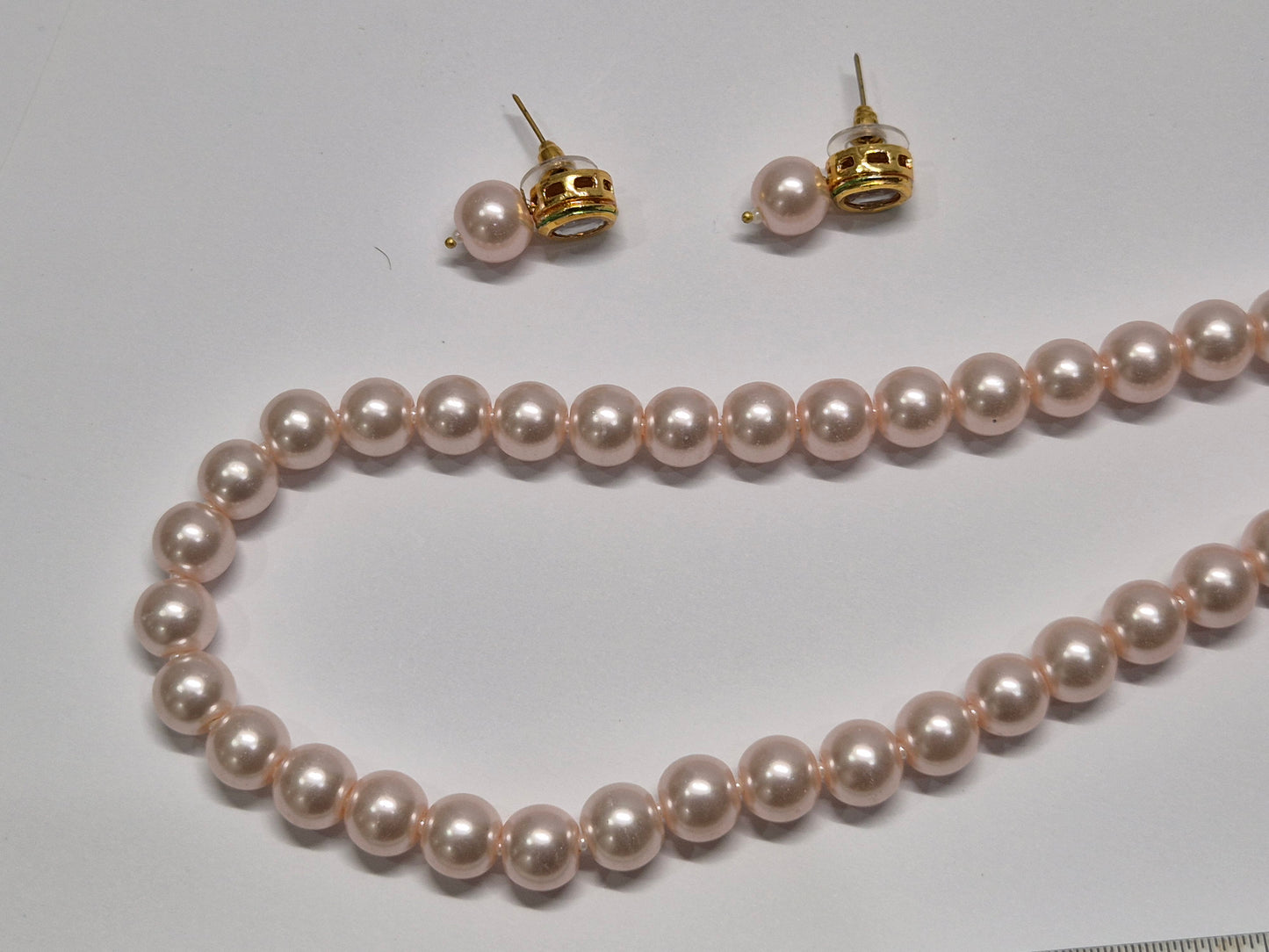 Round light pink pearl necklace set with soft, glossy sheen