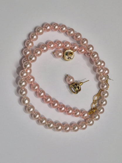 Round light pink pearl necklace set with soft, glossy sheen