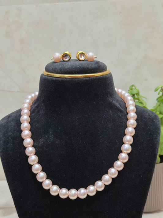 Round light pink pearl necklace set with soft, glossy sheen